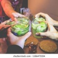 friends-hands-holding-brazilian-caipirinha-260nw-1186473334